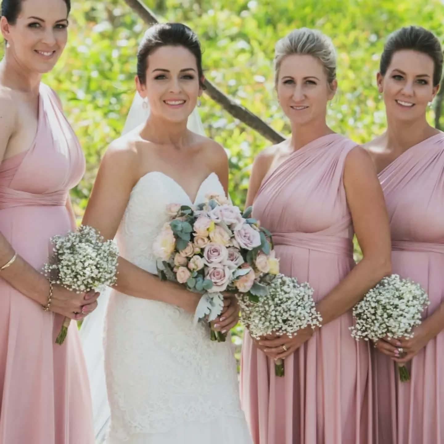 Bride and attendants holding floral bouquets